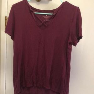 Magenta top. Open neck with criss-crossed fabric. Size medium.